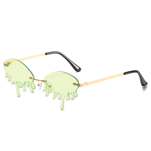 Rimless sunglasses with dark gray dripping liquid-shaped lenses, silver studs, and gold metal frames. - Image 6