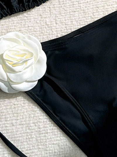 Black two-piece bikini with white 3D flower embellishments on the triangle top and tie-side bottom. - Image 12
