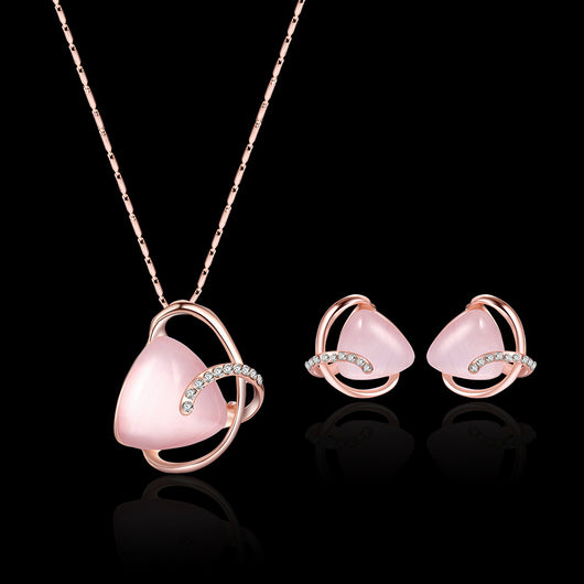 Rose gold-toned necklace and stud earrings set with triangular pink stones and clear rhinestone accents. - Image 12