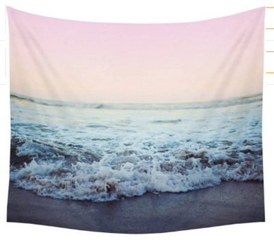 Rectangular tapestry featuring a serene beach scene with foamy ocean waves breaking on the shore under a soft pink and beige sky.