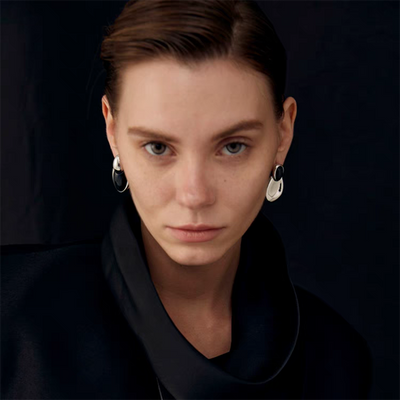 Pair of gold-toned irregular earrings with black onyx-like inserts, featuring a modern, abstract design. - Image 19