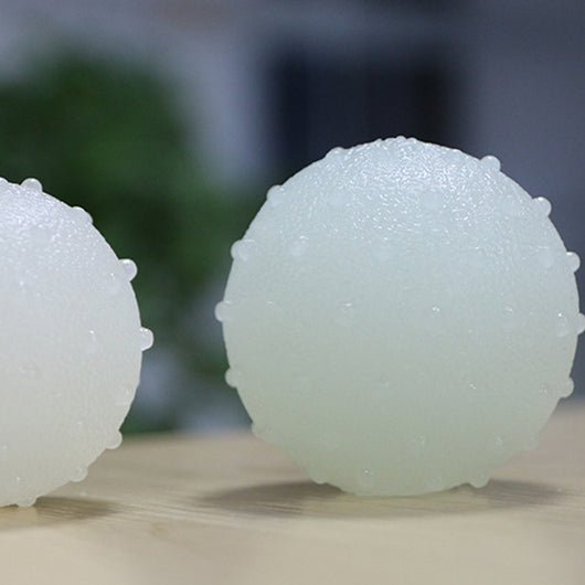 Interactive pet glow ball, off-white in daylight and glowing green in the evening, with a textured surface. - Image 4