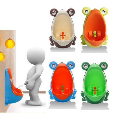 Green and orange frog-shaped children's urinal with large eyes and a spinning target for potty training.