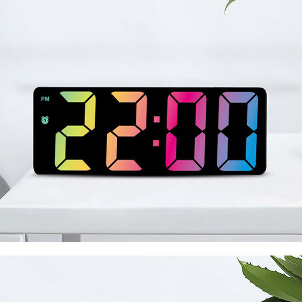 Modern rectangular digital alarm clock with a mirrored face and large, colorful LED numbers displaying the time.