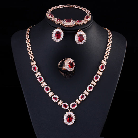 Rose gold tone jewelry set with oval blue gemstones and clear accents, including a necklace, bracelet, earrings, and ring. - Image 2