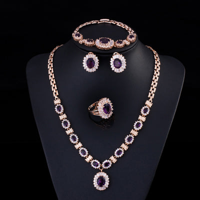 Rose gold tone jewelry set with oval blue gemstones and clear accents, including a necklace, bracelet, earrings, and ring. - Image 10