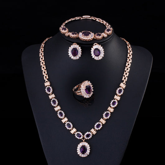 Rose gold tone jewelry set with oval blue gemstones and clear accents, including a necklace, bracelet, earrings, and ring. - Image 10