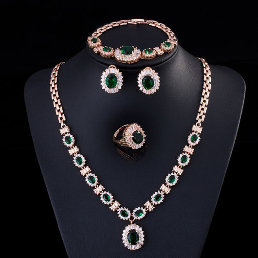 Rose gold tone jewelry set with oval blue gemstones and clear accents, including a necklace, bracelet, earrings, and ring. - Image 8