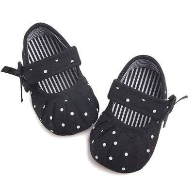 Black baby girl Mary Jane shoes with white polka dots, a strap, bow accent, and striped lining. - Image 25