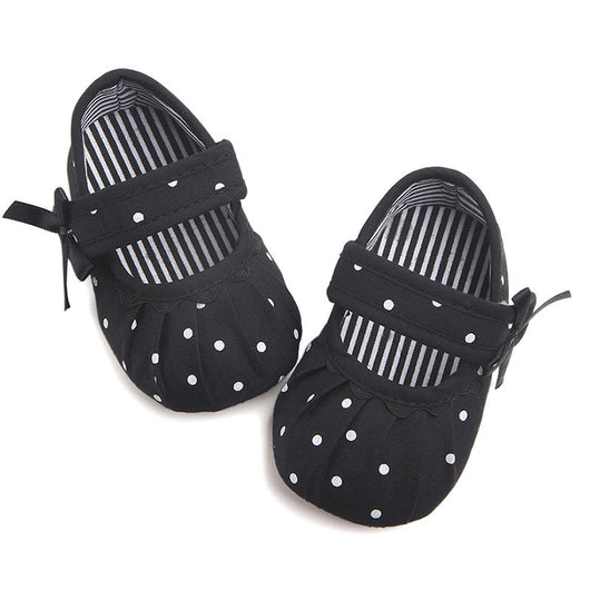 Black baby girl Mary Jane shoes with white polka dots, a strap, bow accent, and striped lining. - Image 25