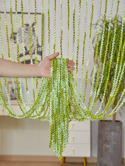 Brown and beige striped string curtain with twisted tassel texture, held by a hand, for living room partition. - Image 9