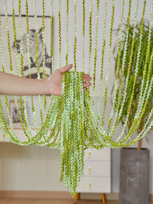 Brown and beige striped string curtain with twisted tassel texture, held by a hand, for living room partition. - Image 9