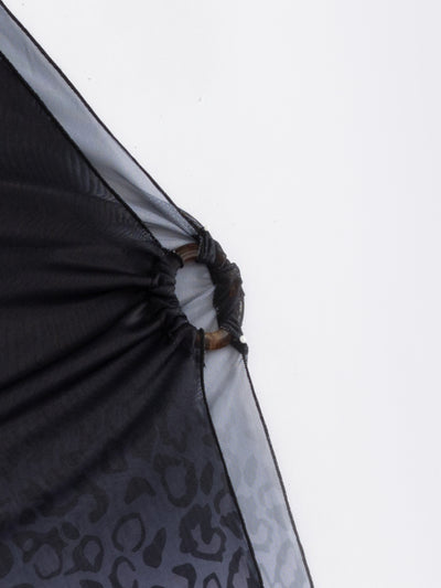 Woman in a three-piece leopard print bikini and sheer black sarong cover-up on a sunny beach. - Image 11