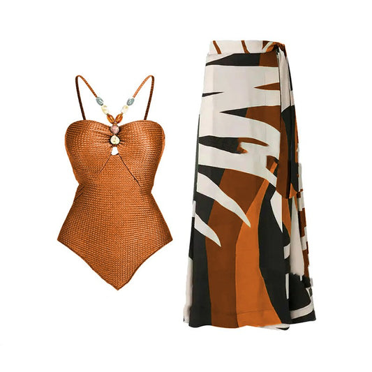 Women's olive green ribbed one-piece swimsuit with colorful beaded straps and matching abstract print sarong skirt.