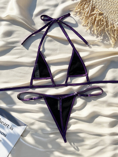 Shiny purple pearlescent micro bikini with a halter top and g-string bottom, modeled by a woman outdoors. - Image 8