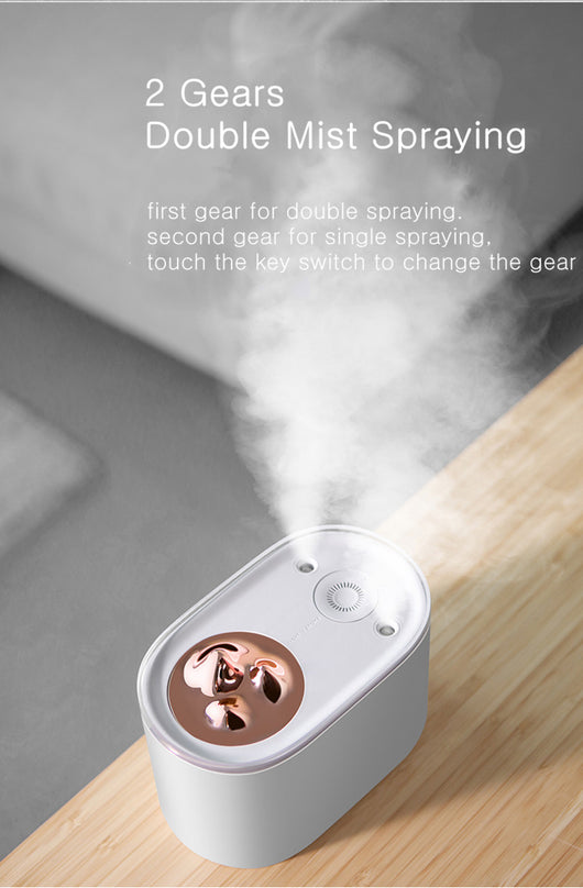 White portable humidifier with rose gold mountain-shaped mist outlet, 1000ml capacity, and compact design. - Image 10