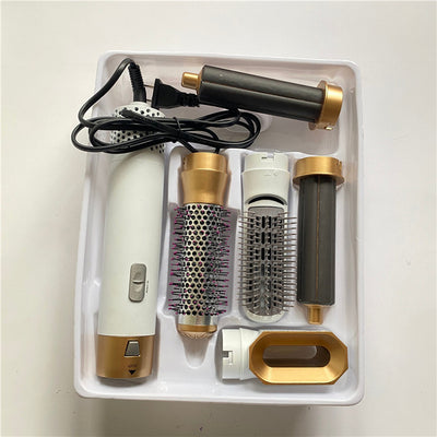 5-in-1 hot air comb hair dryer set with multiple rose red and gray attachments in a white tray. - Image 18