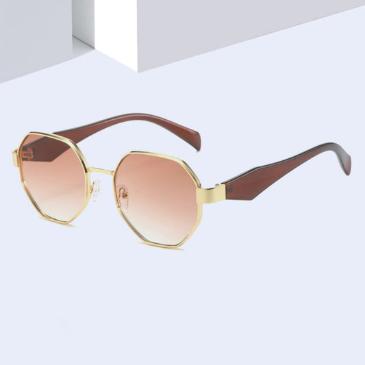 Polygonal sunglasses with a gold metal frame, beige temples, and dark black-gray lenses on a white background.