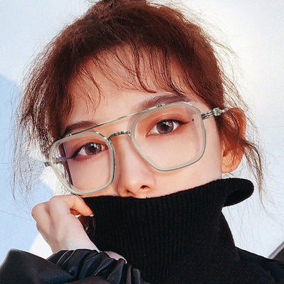 Black and gold double beam retro square frame anti-blue light glasses held by a hand.