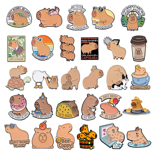 Cute capybara enamel brooch wearing a pink donut with sprinkles and "DONUT WORRY BE CAPPY" text.