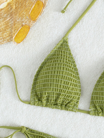 Women's lime green halter bikini with spaghetti straps and thong bottom, modeled outdoors against a blue sky. - Image 27