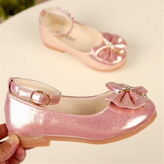 Shiny pink children's ballet flats with ankle straps, decorative bows, and rhinestone embellishments. - Image 3