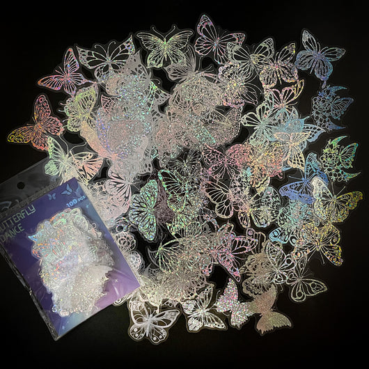 Transparent holographic butterfly laser stickers in various designs, including floral and moon elements, shown individually and in a 100-sheet pack. - Image 2