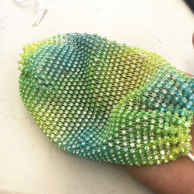 Close-up of a blue mesh fabric adorned with numerous small, clear rhinestones, creating a sparkling texture. - Image 20