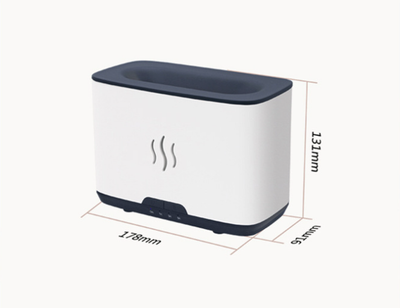 Dark gray rectangular aromatherapy humidifier with an orange flame-like mist and three essential oil bottles. - Image 8