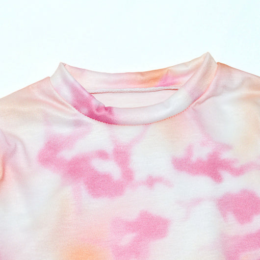 Woman wearing a pink and white tie-dye long-sleeve top and matching pants set, posing casually. - Image 20