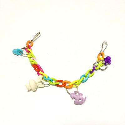 Colorful acrylic chain suspension bridge swing toy with hanging charms for parrots, installed in a white bird cage. - Image 4