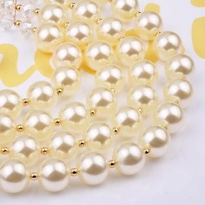 Multi-strand faux pearl and crystal necklace with matching drop earrings on a black jewelry bust. - Image 4