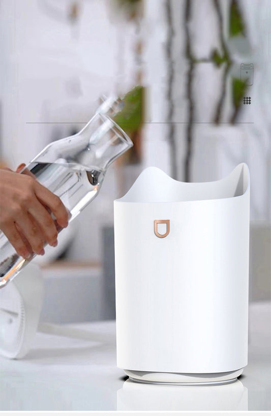 Beige double nozzle humidifier with cat ear design emitting mist, shown in a warm-toned indoor setting.