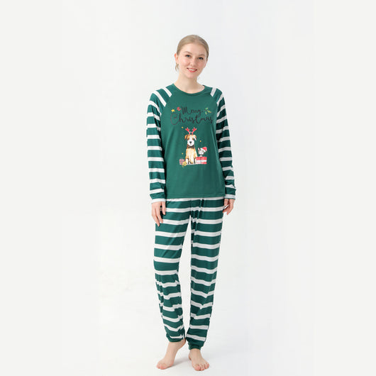 Woman in a Christmas pajama set with a white top, green sleeves, dinosaur graphic, and green fair isle pants. - Image 5