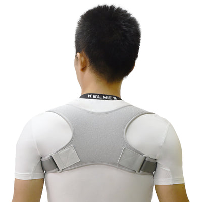 Black back shoulder spine posture corrector worn over a white long-sleeved shirt, showing adjustable straps. (2 pcs) - Image 14