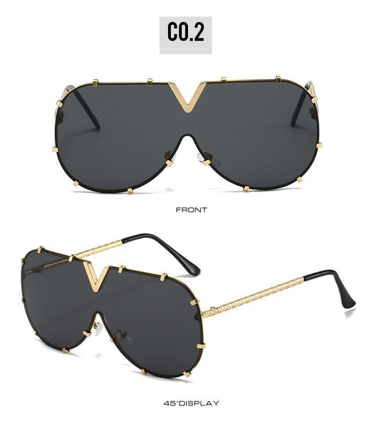 Oversized V-shaped sunglasses with a gold metal frame, white accents, clear lenses, and decorative rivets. - Image 17