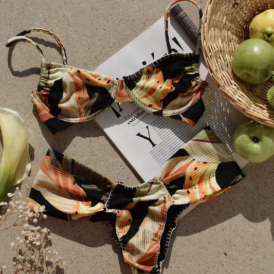 Tropical leaf print bikini with underwire gathered top and high-waisted bottoms in orange, yellow, and black. - Image 2