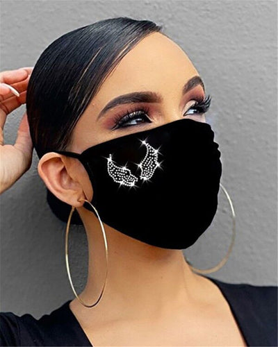 Black cotton face mask with a rhinestone flower design and "Be Kind" in pink rhinestones, worn by a person. - Image 14