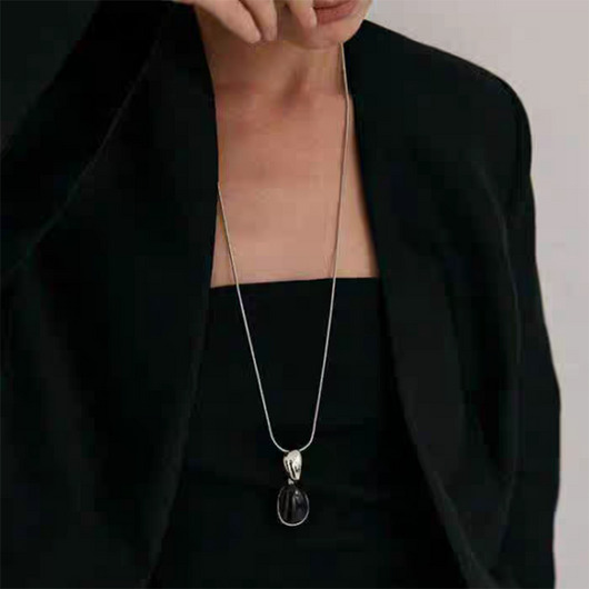 Pair of gold-toned irregular earrings with black onyx-like inserts, featuring a modern, abstract design. - Image 10