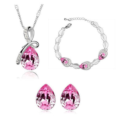 Pink teardrop crystal jewelry set with silver-tone necklace, bracelet, and stud earrings, accented with clear stones. - Image 10