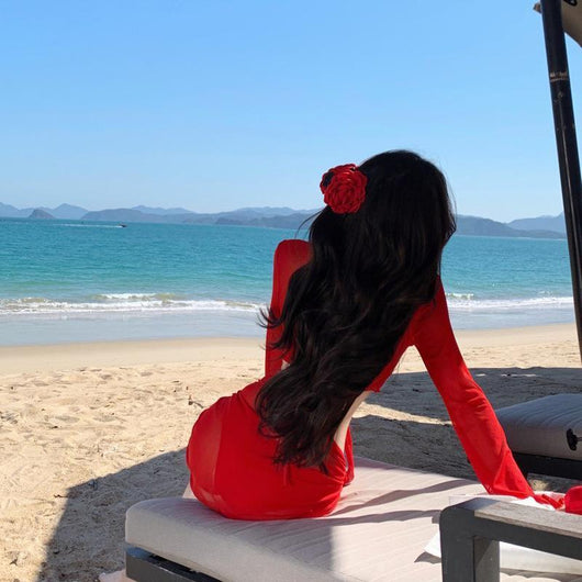 Red four-piece bikini set with sheer long-sleeve tie-front top and matching tie-front skirt on a beach. - Image 3