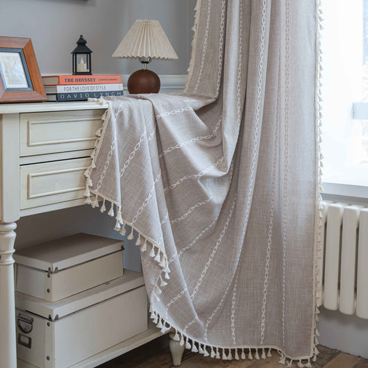 Black polyester curtain with white jacquard multi-line pattern and black tassels, draped over a white chair. - Image 12