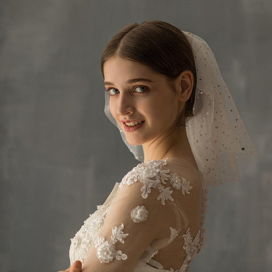 White multi-layer short bridal veil with gold star embellishments, worn by a model in a white lace wedding dress. - Image 2
