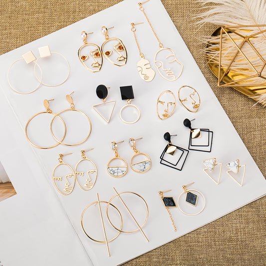 Pair of silver geometric round hoop earrings with a small circular stud and thin, large hoops.