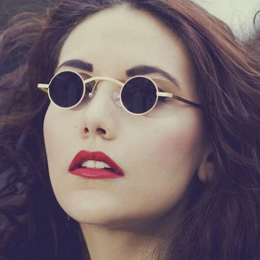Small frame retro round sunglasses with black metal frames and brown polarized lenses, angled on a white background.