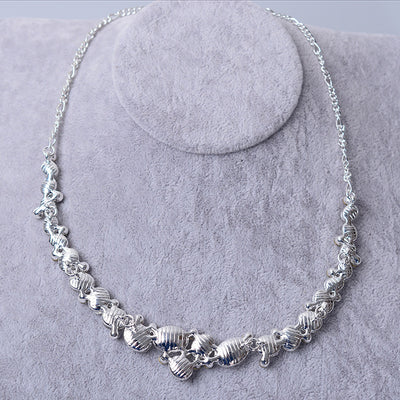Silver-tone bridal necklace and matching drop earrings set with clear oval and round rhinestones, displayed on a gray velvet stand. - Image 4