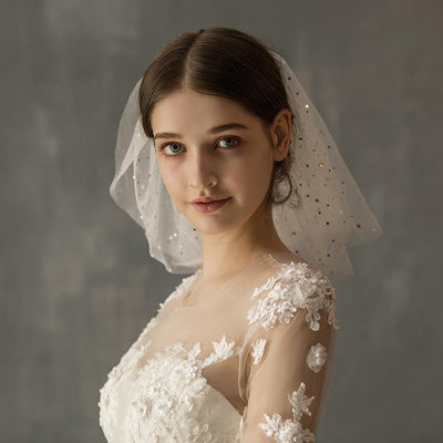 White multi-layer short bridal veil with gold star embellishments, worn by a model in a white lace wedding dress. - Image 6