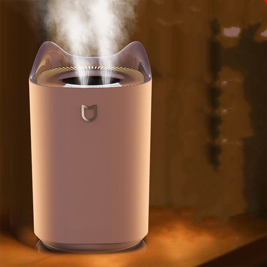 Beige double nozzle humidifier with cat ear design emitting mist, shown in a warm-toned indoor setting. - Image 5