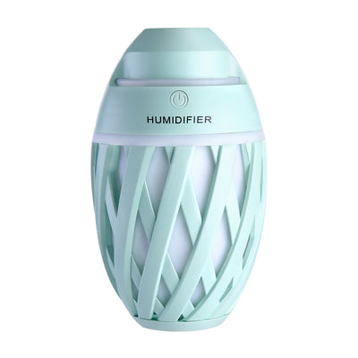 Light green football-shaped humidifier with a decorative lattice pattern and a power button on top. - Image 25