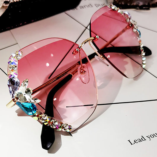 Oversized rimless sunglasses with gradient gray lenses and colorful rhinestone embellishments along the top and sides. - Image 3